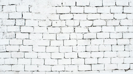 Old white brick wall with cracks