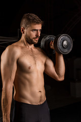 Plakat Muscular bodybuilder handsome man doing exercises in outdoor gym naked torso