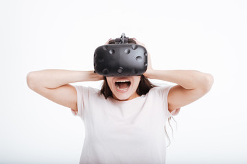 Screaming scared lady wearing virtual reality device