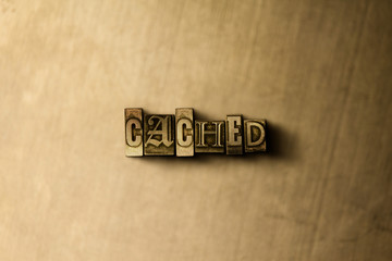 CACHED - close-up of grungy vintage typeset word on metal backdrop. Royalty free stock - 3D rendered stock image.  Can be used for online banner ads and direct mail.