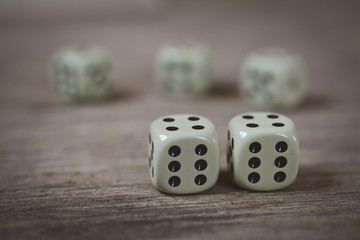 two dice number double six on a wooden table
