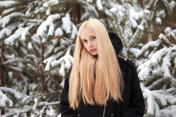 girl in a snowy winter forest. slum