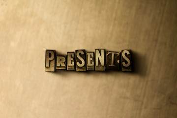 PRESENTS - close-up of grungy vintage typeset word on metal backdrop. Royalty free stock - 3D...