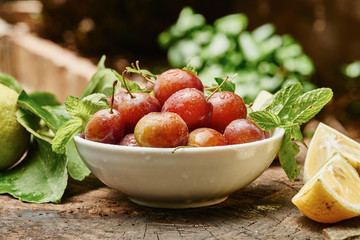 Plums in bowl on wood