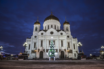 Fototapeta na wymiar Christmas tree near the Cathedral of Christ the Savior in the late evening, Moscow, Russia