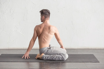 Fototapeta na wymiar A man doing yoga exercises