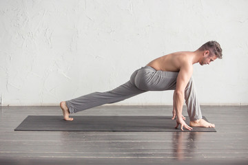 A man doing yoga exercises