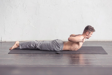 Fototapeta na wymiar A man doing yoga exercises