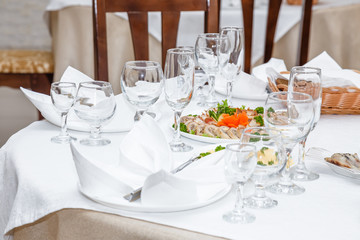 Cutlery and cold cuts served on a festive table in restaurant