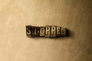 STOPPED - close-up of grungy vintage typeset word on metal backdrop. Royalty free stock - 3D rendered stock image.  Can be used for online banner ads and direct mail.