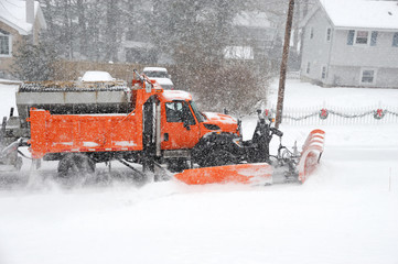 snowplow removing snow in the street after blizzard