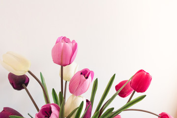 Assorted plastic artificial tulip flowers that are fake in pink