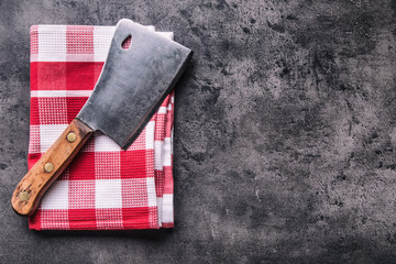 Butcher. Vintage butcher meat cleavers with cloth towel on dark concrete or wooden kitchen  board.