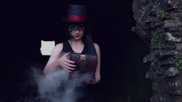 4k Halloween Shot of a Witch Opening a Box with Smoke