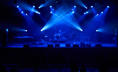Perfect blurred background with blue concert lights, big stage. Electronic music concept.