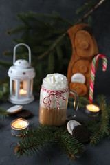 Fototapeta na wymiar Christmas hot chocolate with ornaments and candy cane. Christmas and New Year decorations