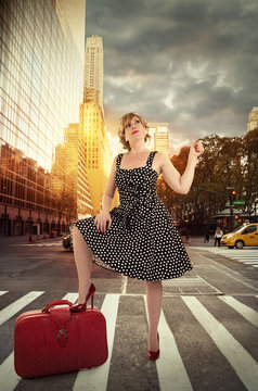 Street in New York city, sunrise in background. Pin up girl in first plan.