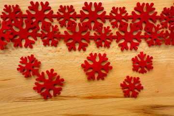 Wooden background, red snowflakes.