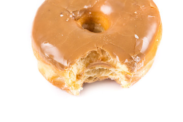 Partally eaten donuts with a bite taken out isolated on a white background