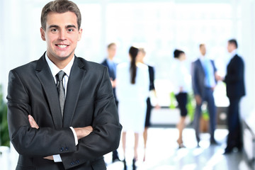 Fototapeta premium Happy mature business man looking at camera with satisfaction at office