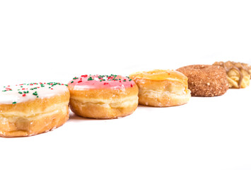 Frosted donut lineup shallow depth of field isolated on a white background