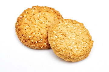 homemade oatmeal cookies sprinkled with sesame seeds on isolated background