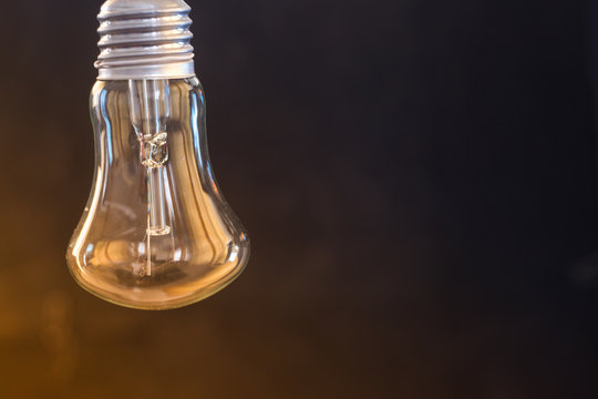 Light bulb on a dark blurred background