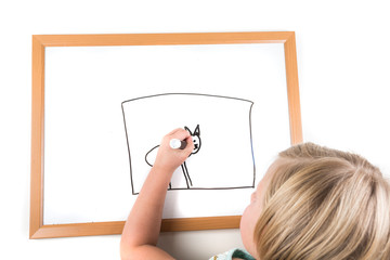 Young girl drawing on a dry erase board with a marker
