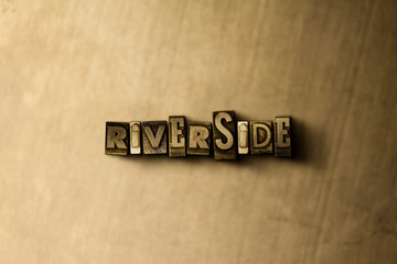 RIVERSIDE - close-up of grungy vintage typeset word on metal backdrop. Royalty free stock - 3D rendered stock image.  Can be used for online banner ads and direct mail.