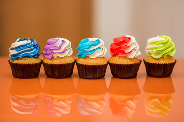 Colorful cupcakes on a bright background
