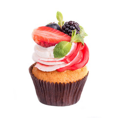 Cupcakes with different berries on a white background. Isolated.