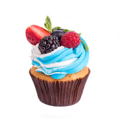 Cupcakes with different berries on a white background. Isolated.