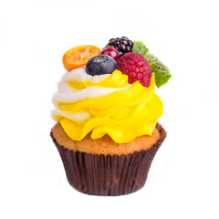 Cupcakes with different berries on a white background. Isolated.