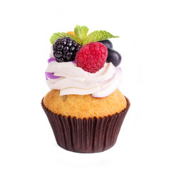 Cupcakes with different berries on a white background. Isolated.