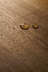 Fototapeta na wymiar Water droplets on a wooden surface