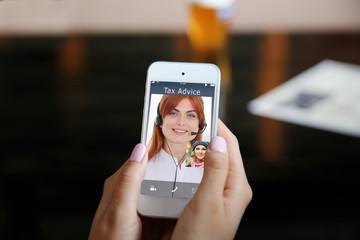 Video conference with financial advisor on smartphone. Investment and tax concept.