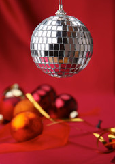 Christmas red balls on a bowl, on red background