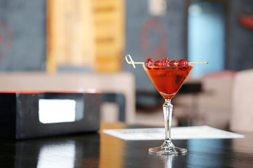 Tasty cocktail on wooden table in bar