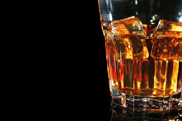 Glass of whisky on dark background