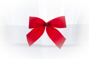 Centered red bow on white fabric