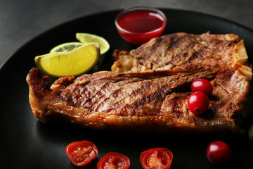 Plate with tasty steak and some ingredients, close up view