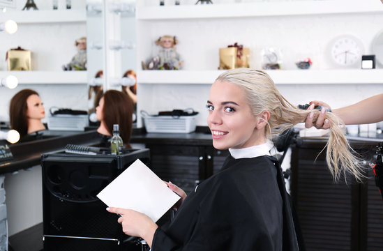 Young blonde woman at hair salon