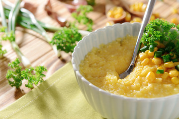 Tasty breakfast of cornmeal porridge on napkin, closeup