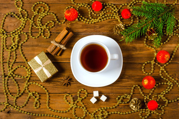 Christmas concept: decoration and a cup of tea on a wooden backg