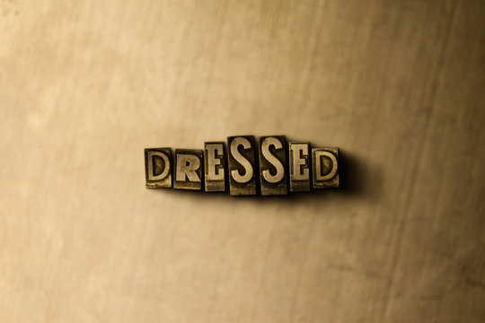 DRESSED - close-up of grungy vintage typeset word on metal backdrop. Royalty free stock - 3D rendered stock image.  Can be used for online banner ads and direct mail.