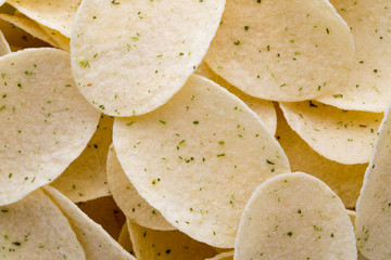 Close up potato chips on wood top view background.