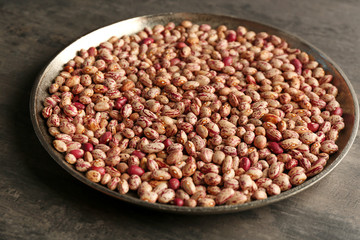 Tray with beans on dark table