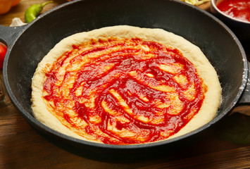 Unbaked pizza in pan, closeup
