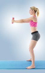 Sporty girl holding weights. Fitness gym concept.