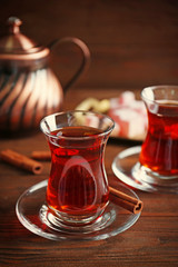 Turkish tea in traditional glass on wooden table closeup